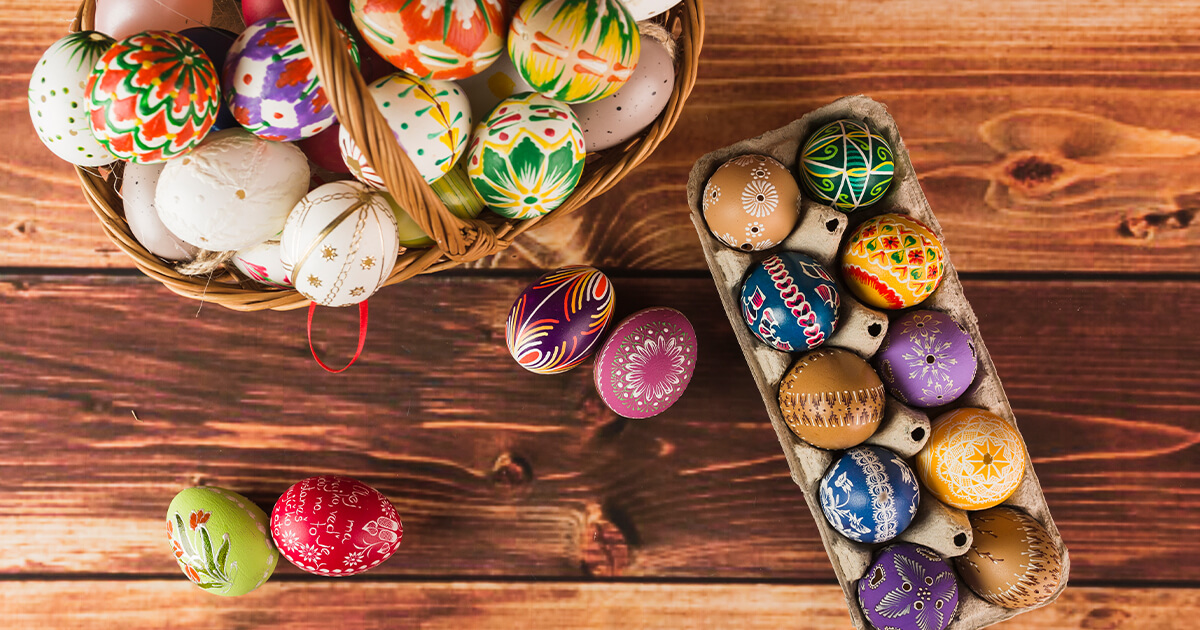 Italian Easter eggs in basket with wood texture behind